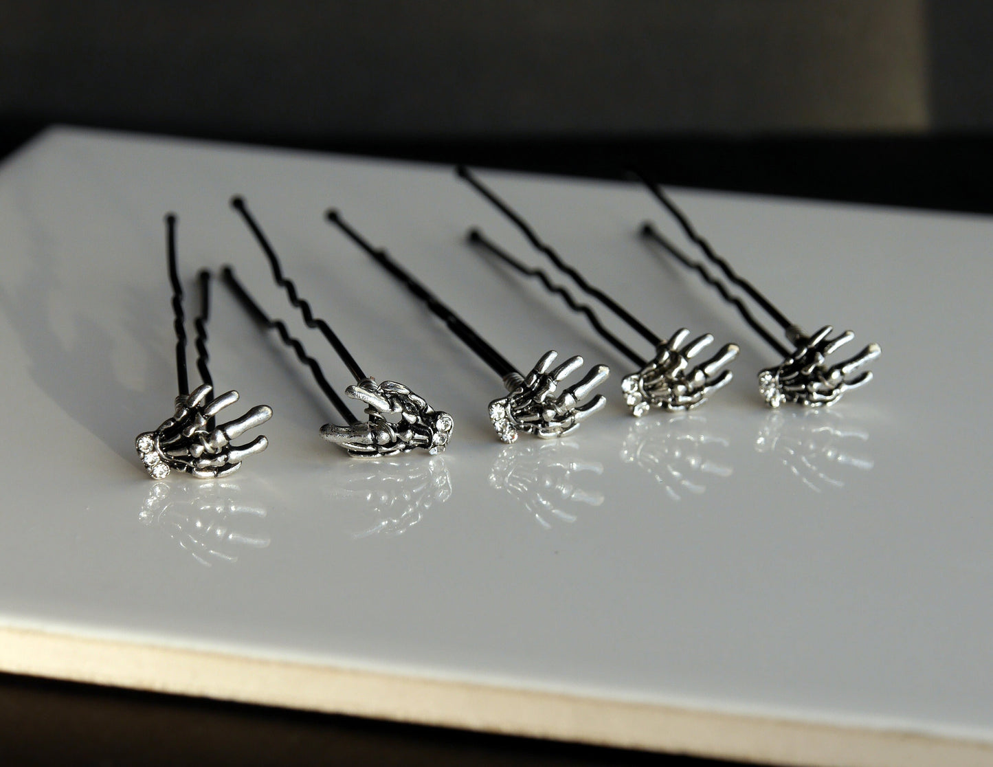 A set of 5 hand made wedding / ballet dance hair pins with silver toned skeleton hands (12 mm x 8 mm). Hands have diamante detail.